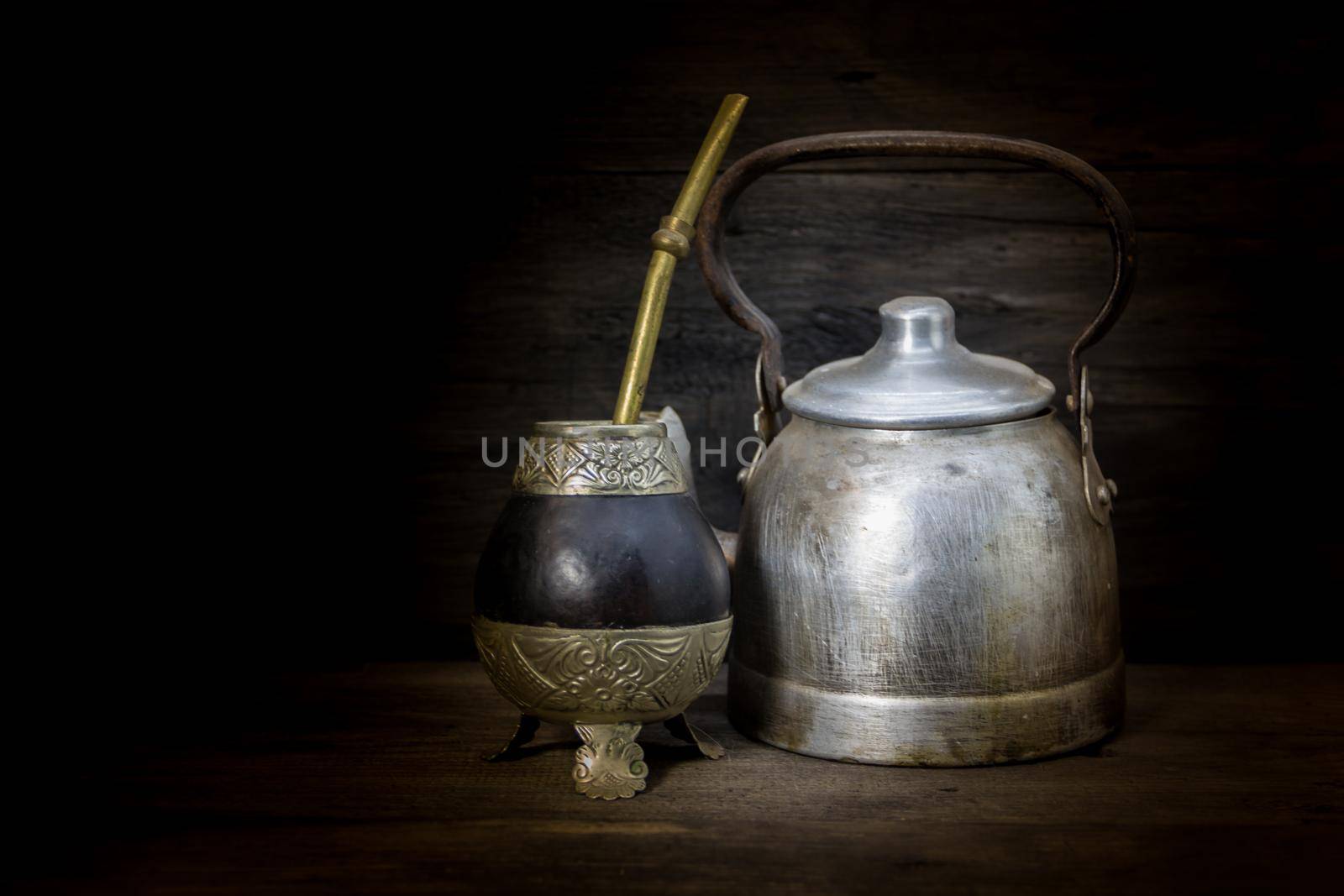 mate and kettle to drink yerba mate on rustic wood. Argentine tradition by GabrielaBertolini