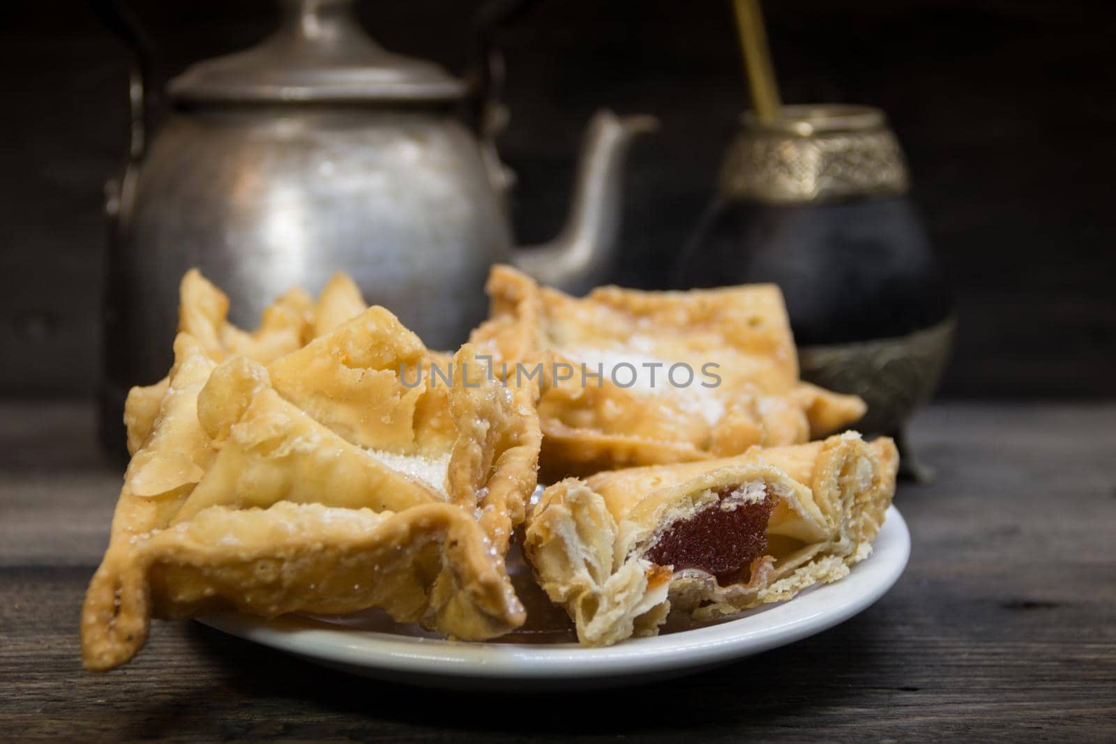 Plate of fried quince and sweet potato pastries with mate.Gastrnomia Argentina