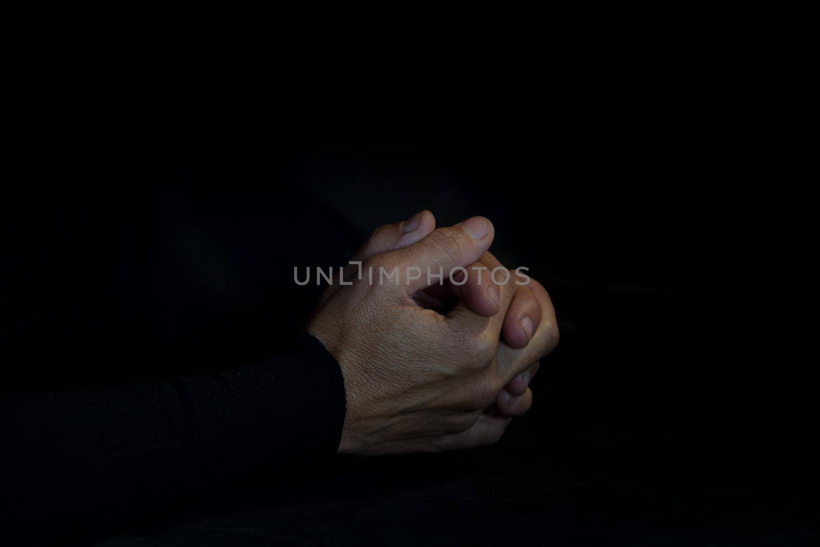 praying hands on black background by GabrielaBertolini