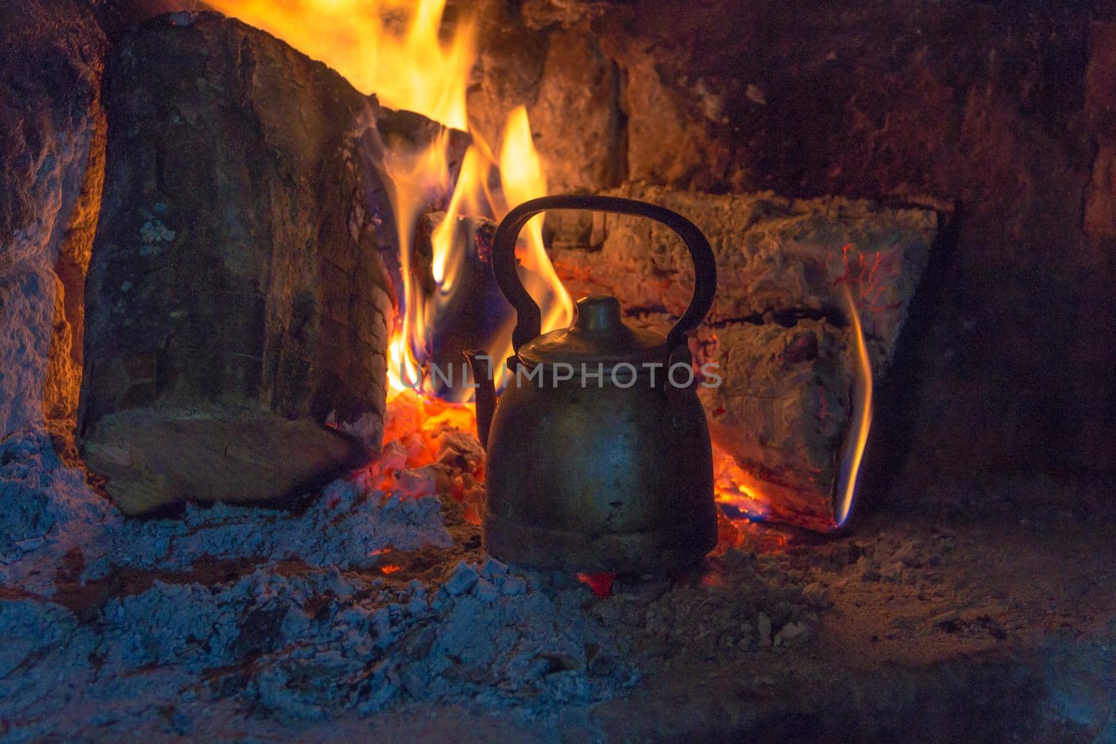 wood stove with kettle heating the water in the field