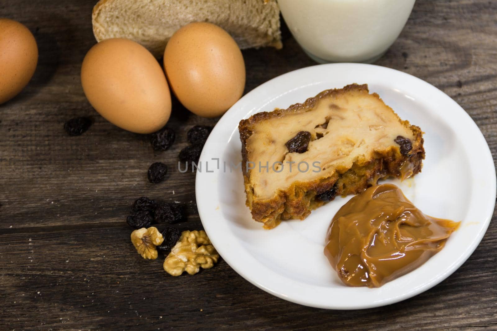 Portion of Bread pudding, made with milk, eggs, stale bread and fruits and Argentine dulce de leche by GabrielaBertolini