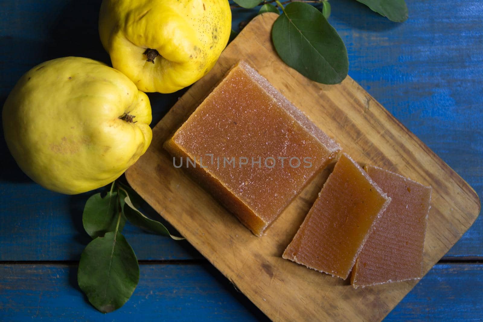 quince jelly and quinces on rustic wooden background
