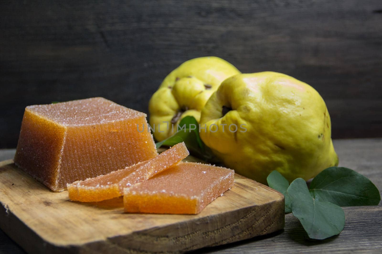 quince jelly and quinces on rustic wooden background by GabrielaBertolini