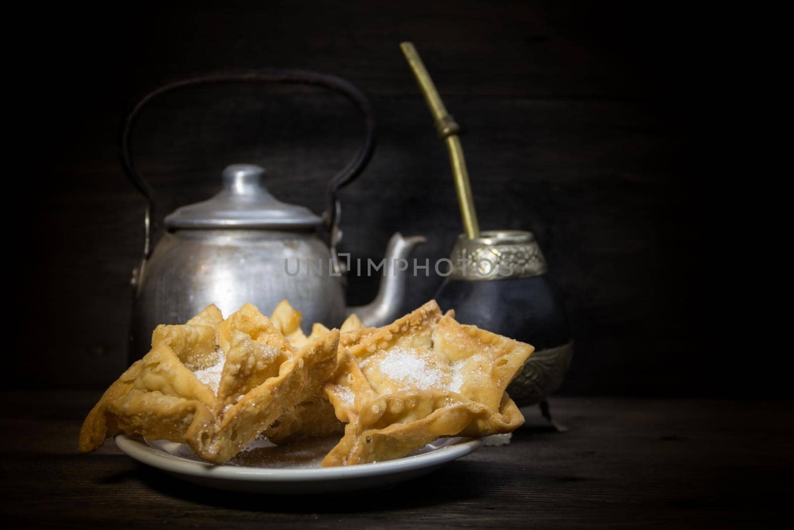 Plate of fried quince and sweet potato pastries with mate.Gastrnomia Argentina