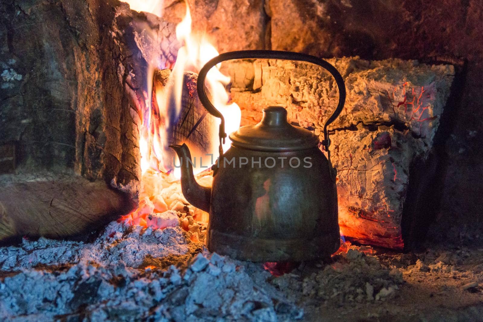 wood stove with kettle heating the water in the field