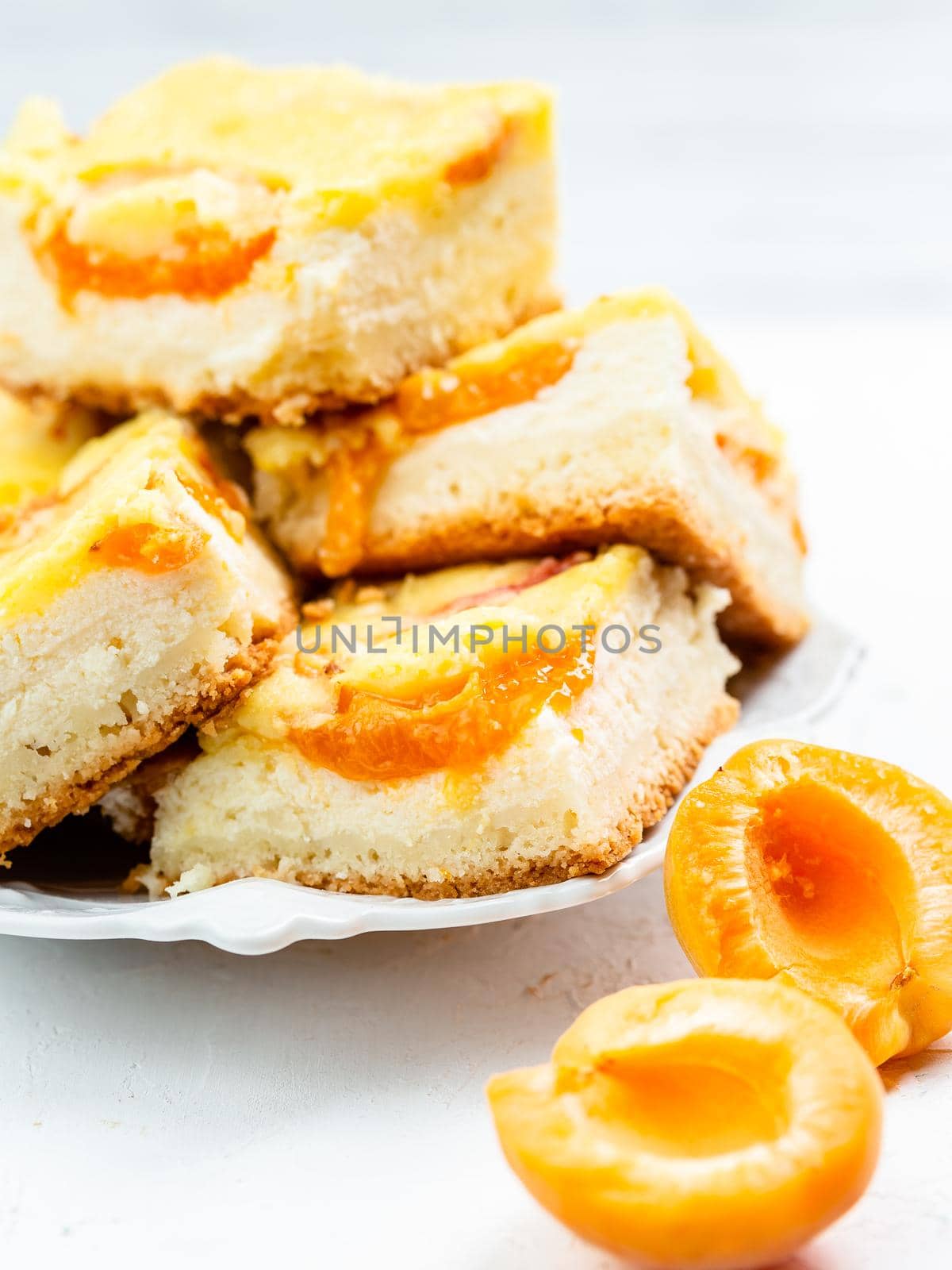 Slice of baked apricot and cheese tart dessert by Syvanych