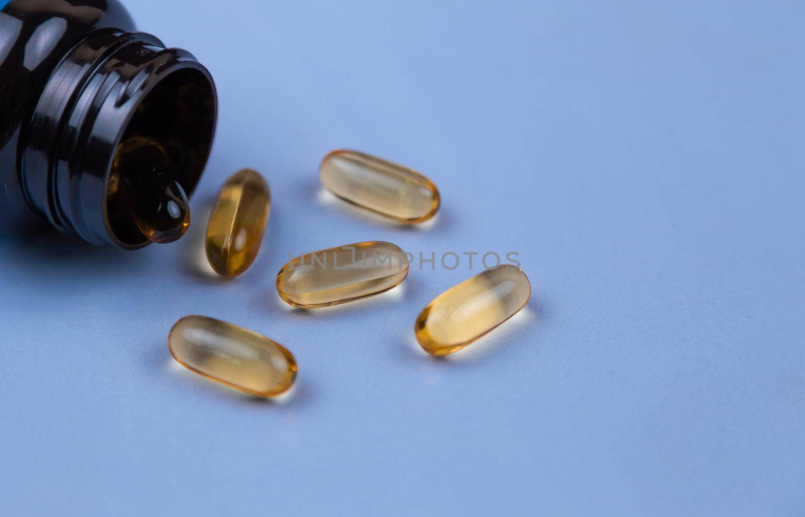 Brown gel capsule pills spread out of drug bottle. Antipsychotic drug. Capsule medicine for treatment depression. Anti-anxiety. Drug. Global healthcare.