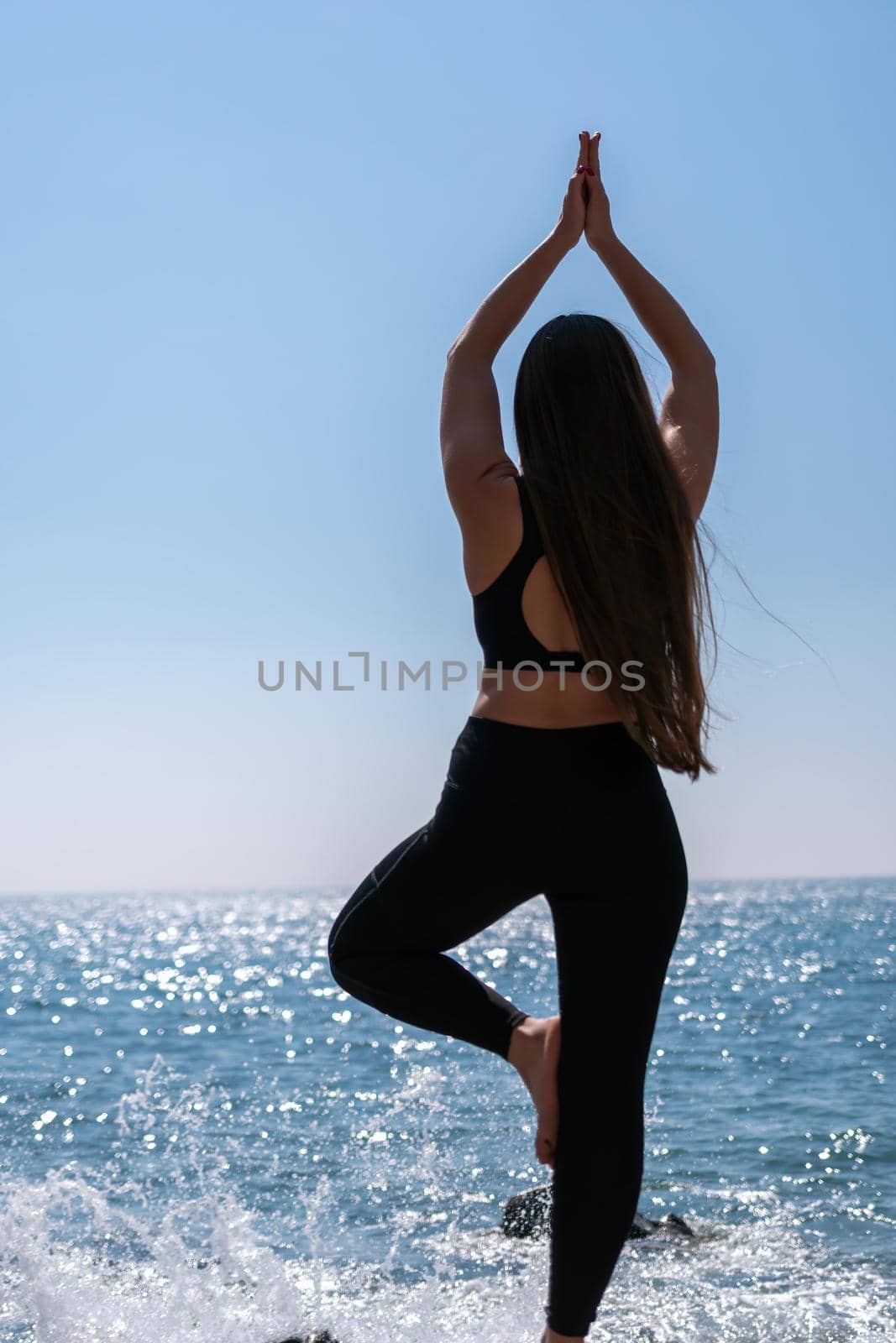 Group of young womans fitness instructor in Sportswear Leggings and Tops, stretching in the gym before pilates, on a yoga mat near the large window on a sunny day, female fitness yoga routine concept.