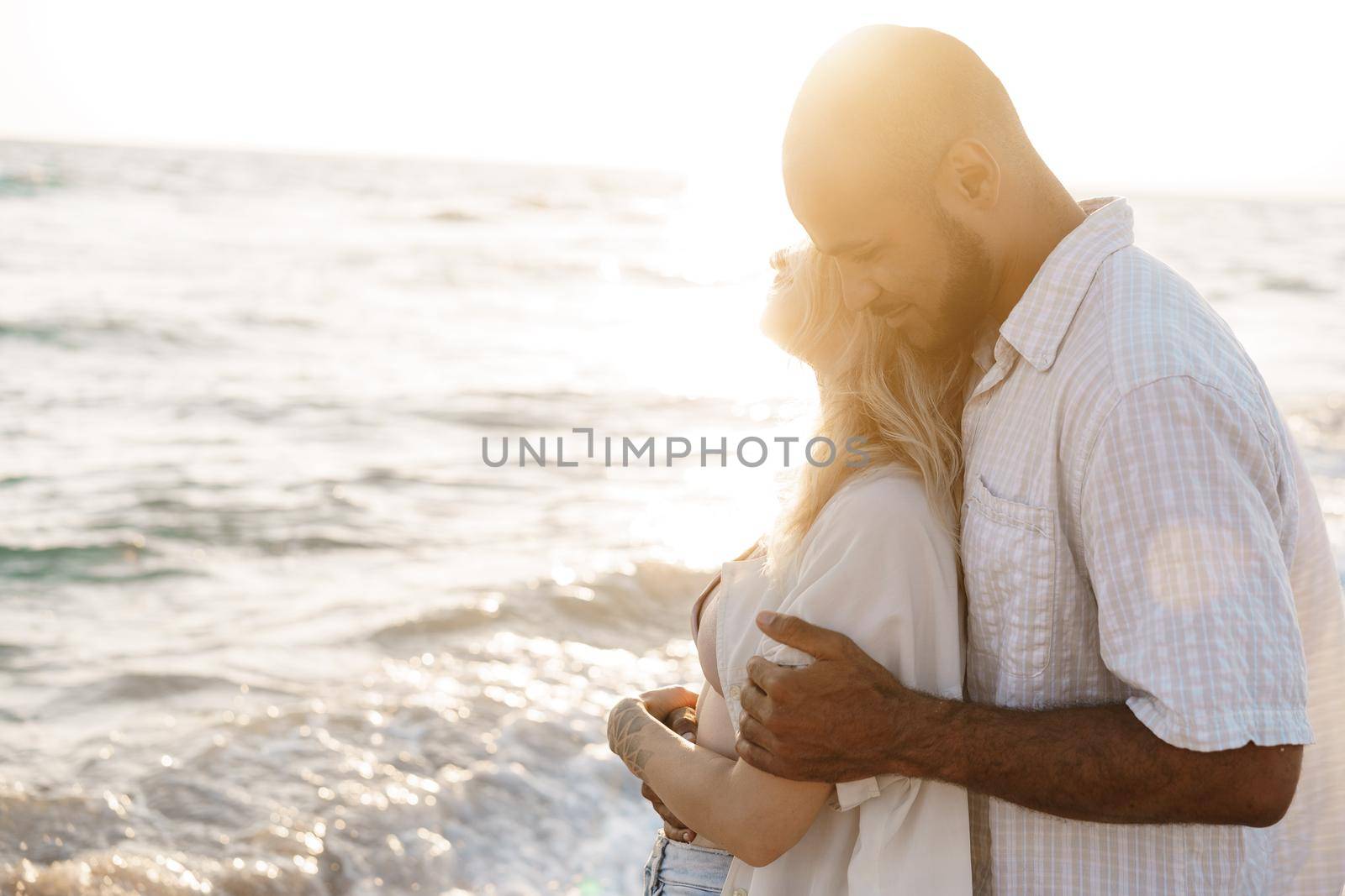 Young happy couple on seashore enjoying the sea, close up