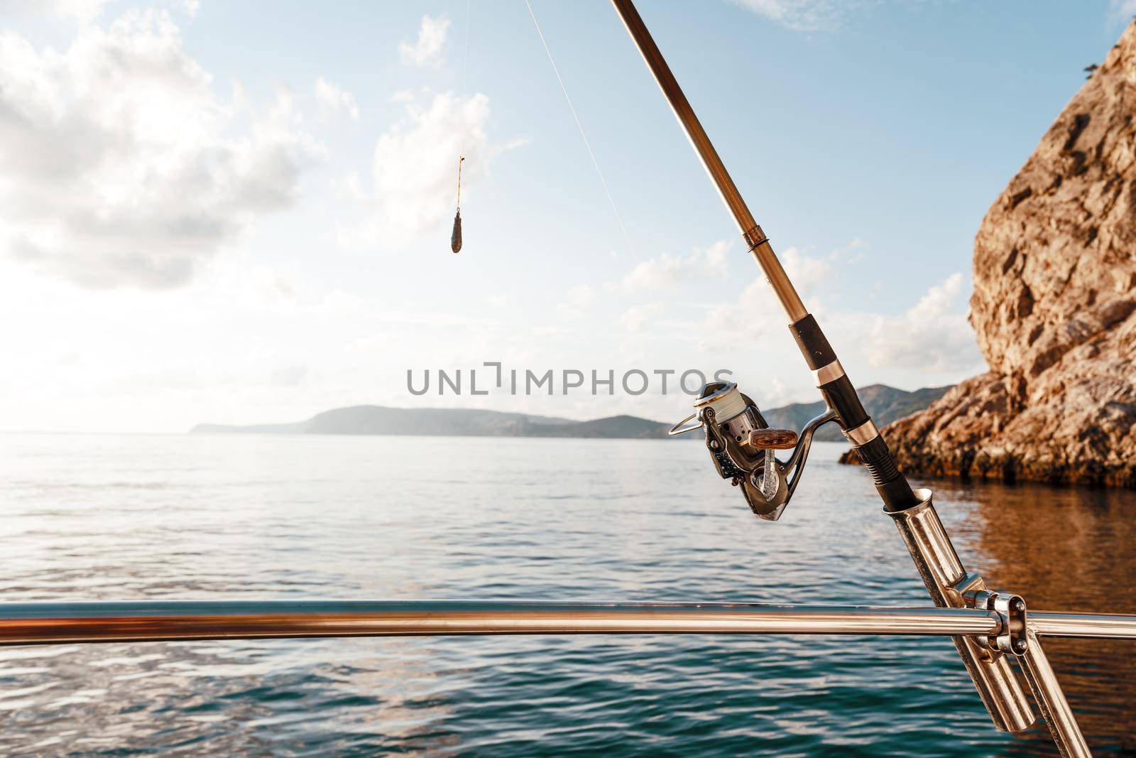 Fishing rod on a sailboat on the background of the open sea