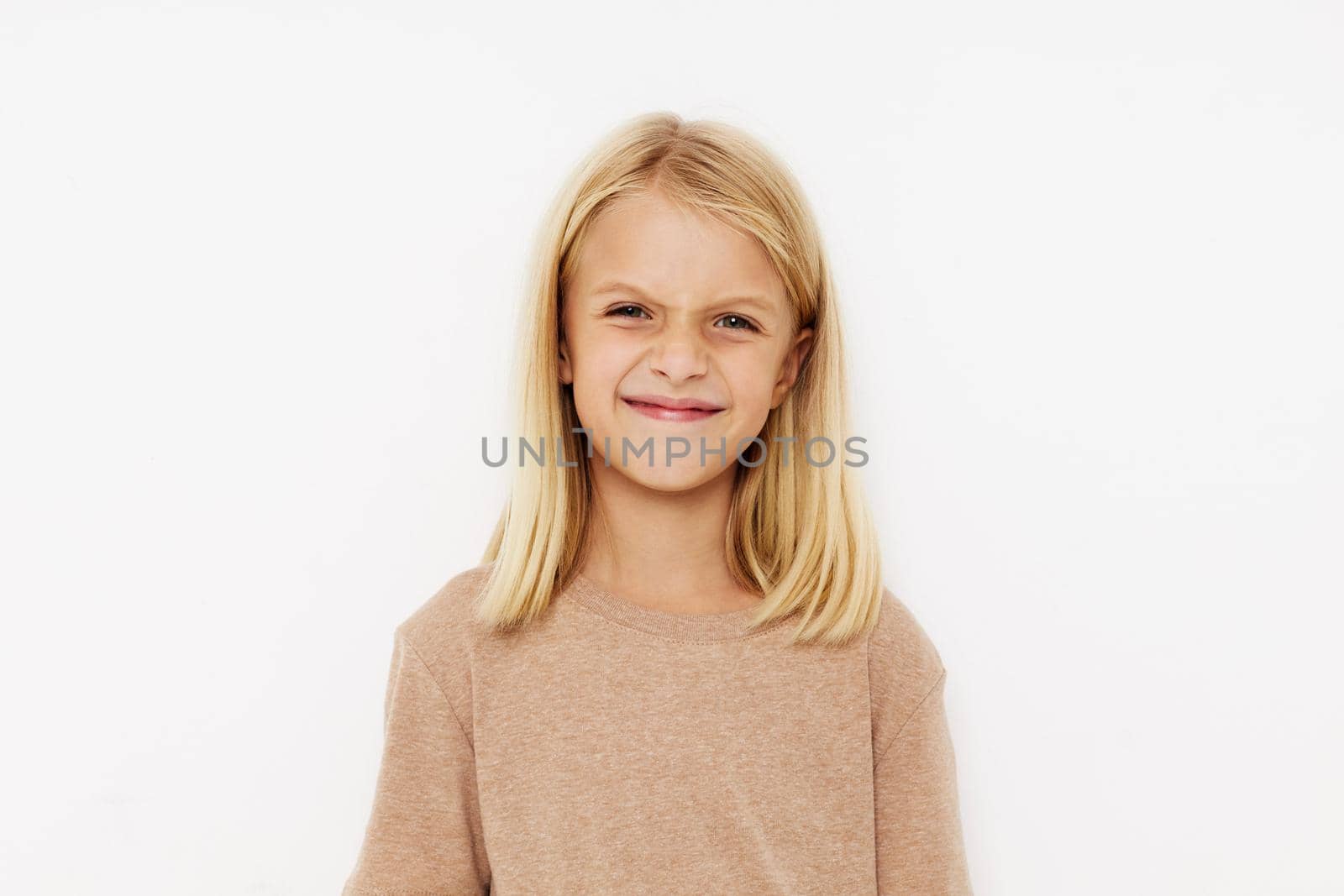 happy child in a beige t-shirt isolated background. High quality photo