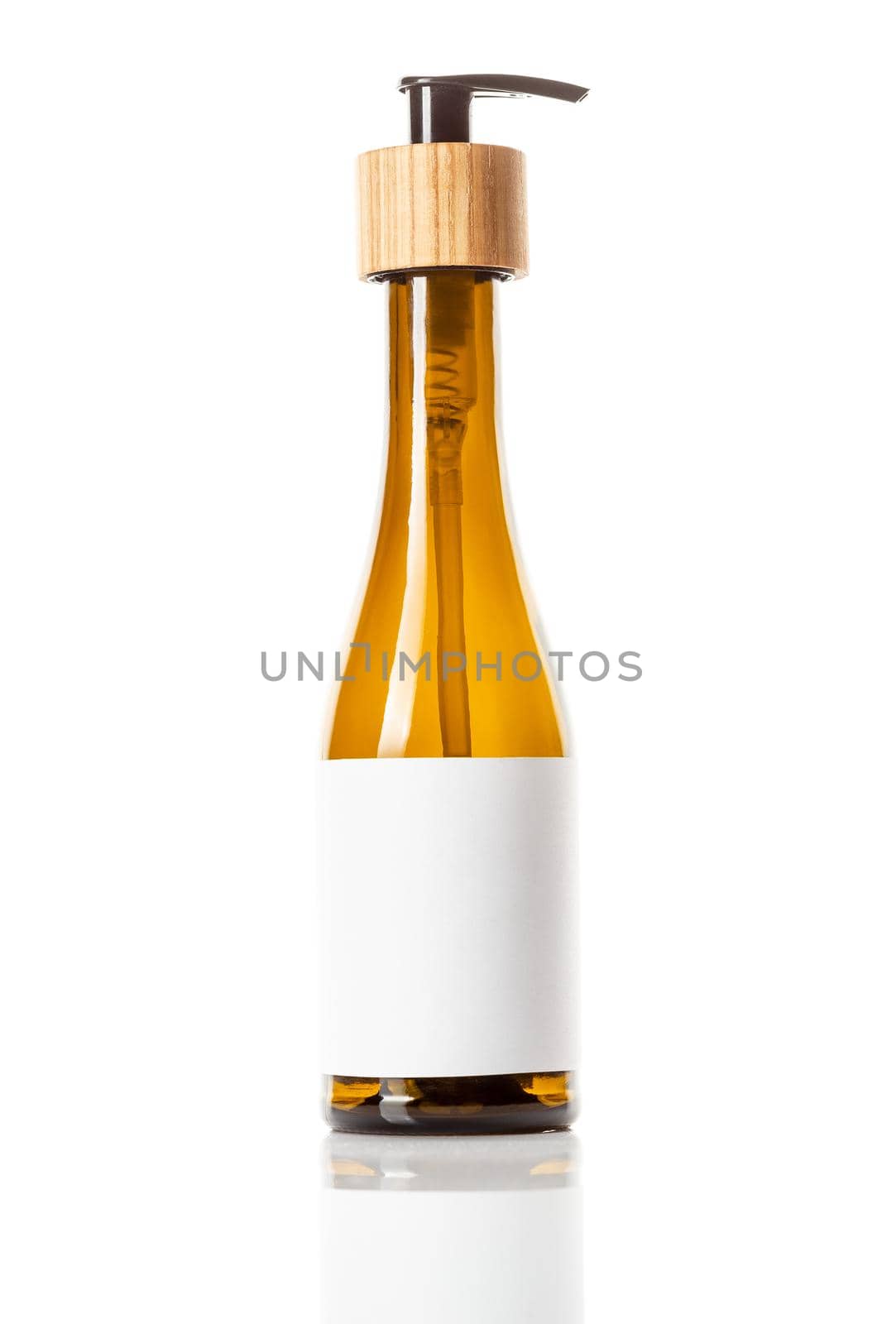 Brown glass pump dispenser bottle for cosmetics, white label with space for text, isolated on white. Bathroom accessory, Beauty product packaging