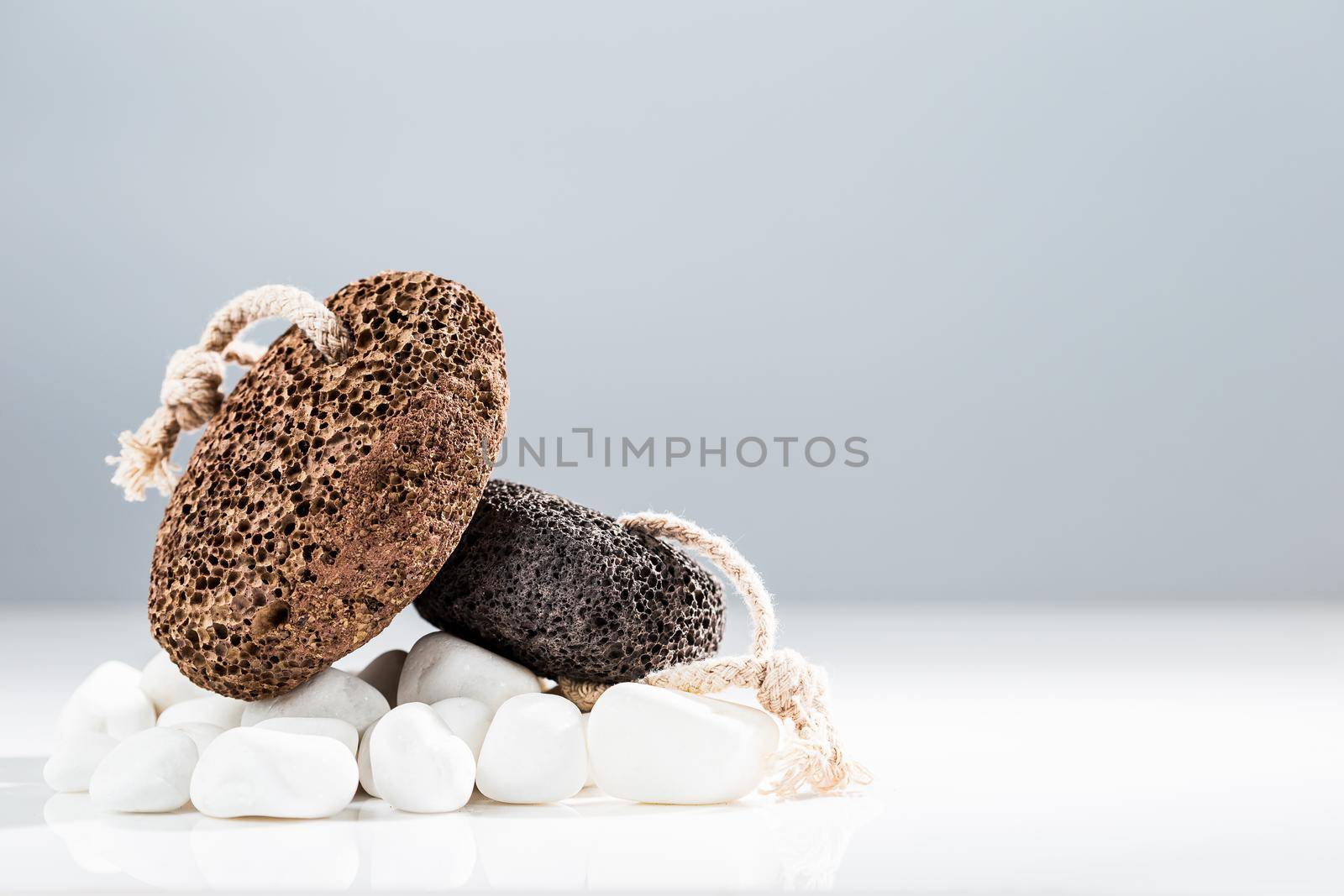 Brown and black pumice stone for home spa over white background