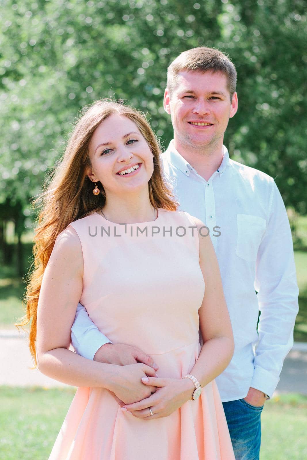 Happy young couple smiling at a nature park