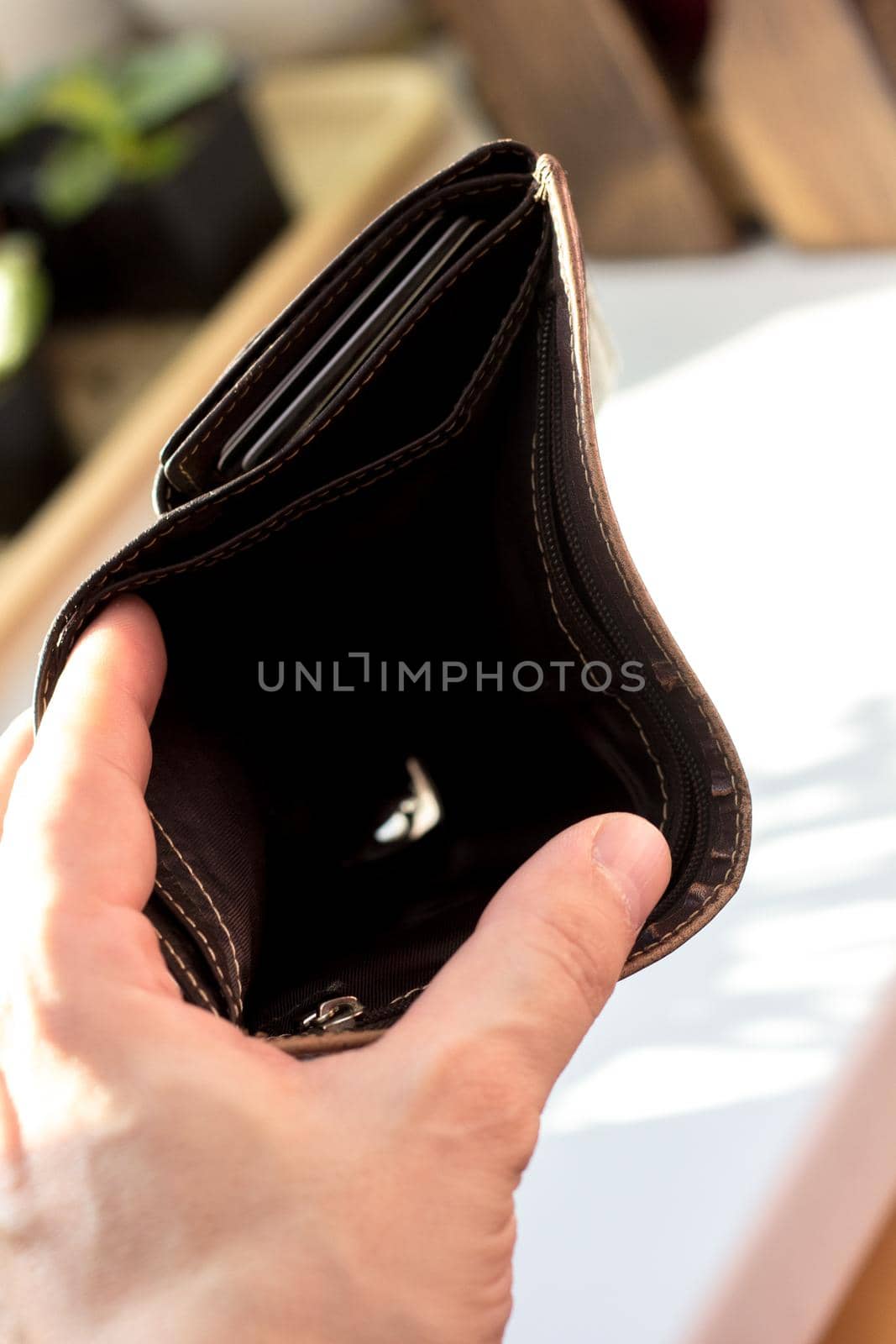 Hand with empty wallet as banrupt concept.