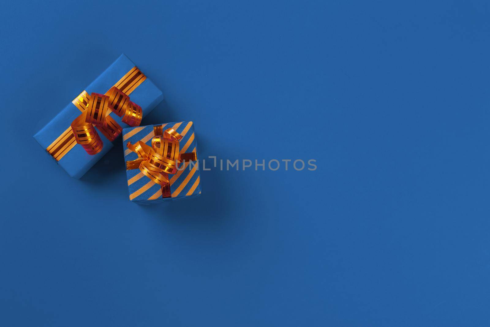 Gift box on classic blue background top view. Close up.
