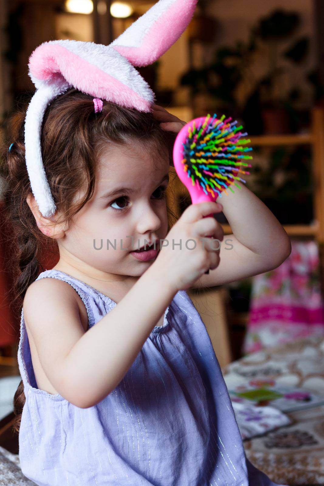 Little kid girl having fun with bunny ears on head