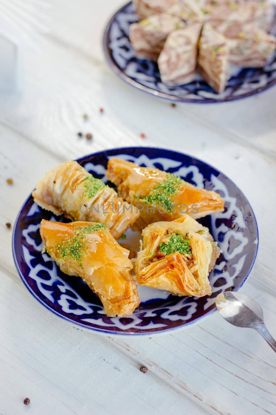 Asian dessert baklava or pahlava on a traditional oriental plate, great image for your needs.