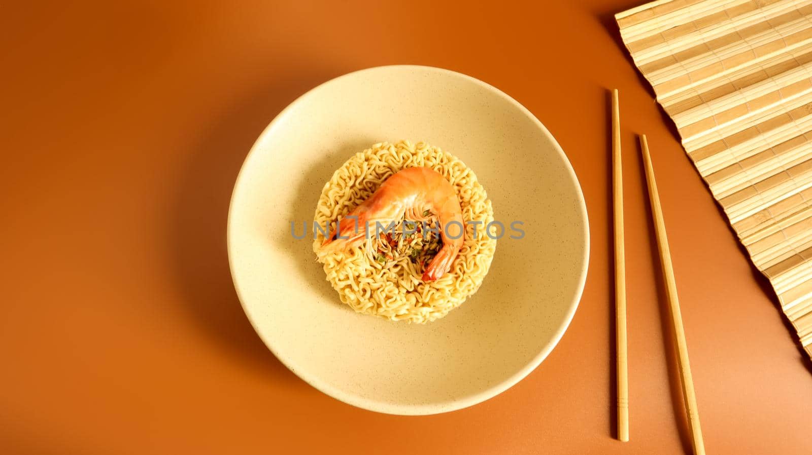 Spicy instant noodle soup with shrimp. shrimp soup, cooking, food. Raw dried circle-shaped vermicelli in a plate. Asian food. pasta, for the preparation of which it is enough to pour boiling water.