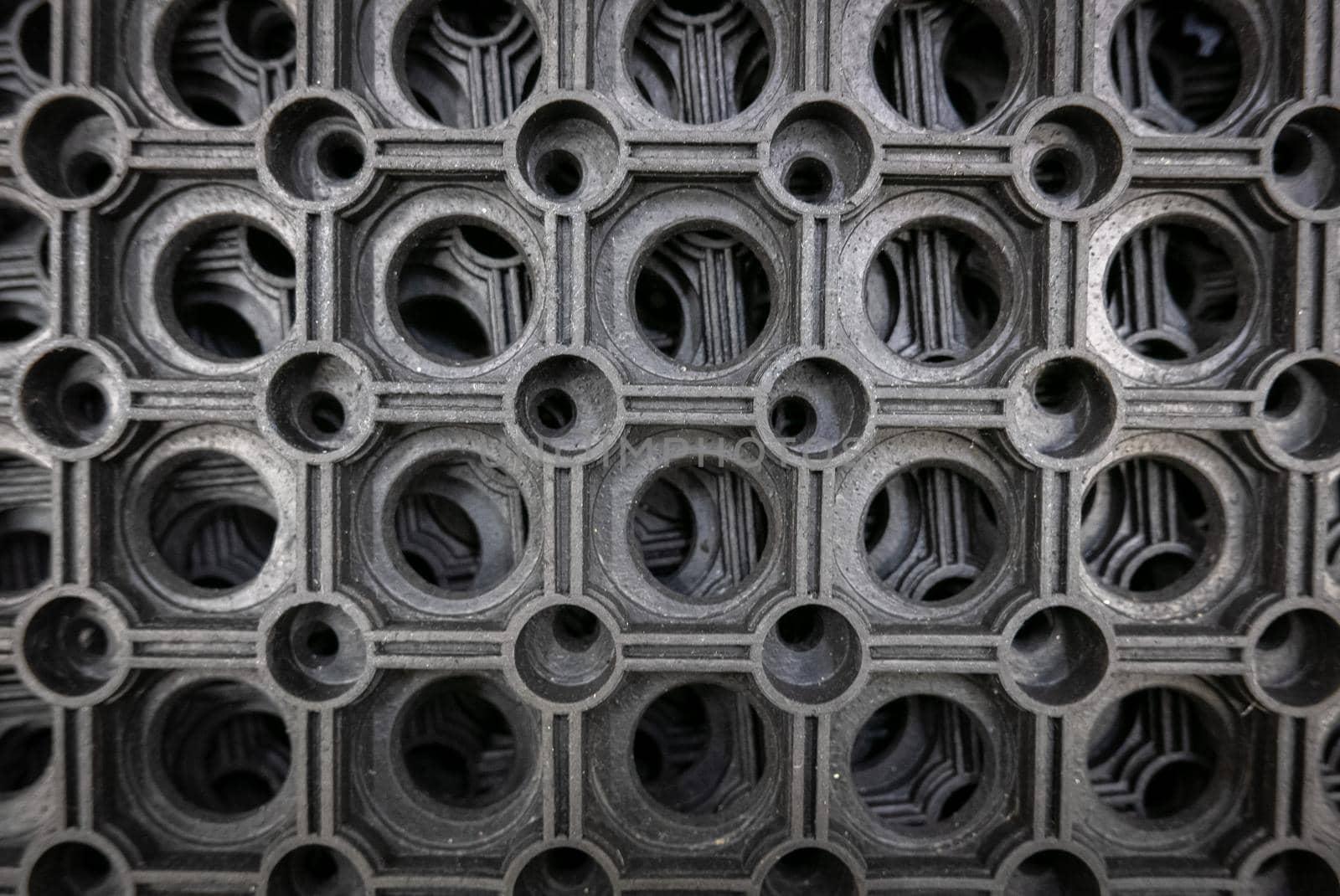 Perforated metal pattern background. Black and gray metal background