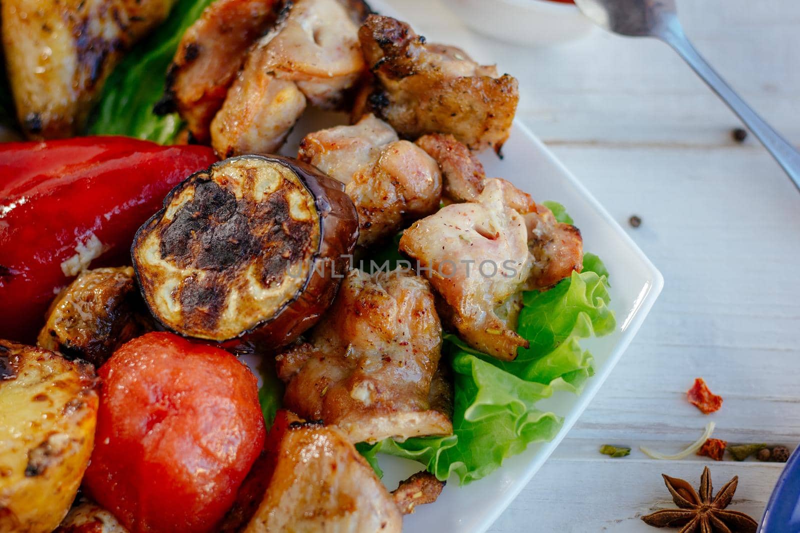 Top view of grilled chicken meat on white plate, great image for your needs.