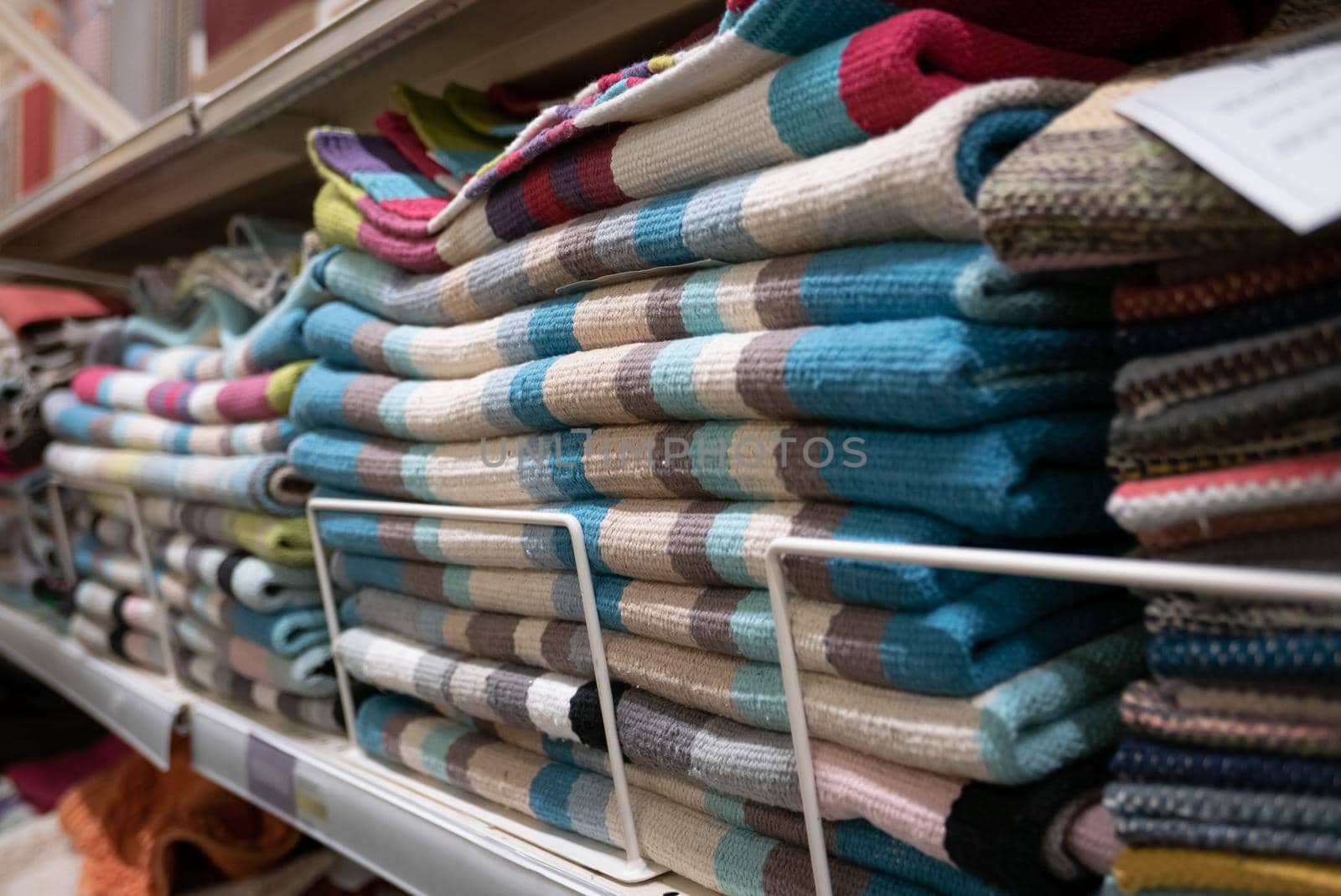 Pile of small welcome carpets or doormats.