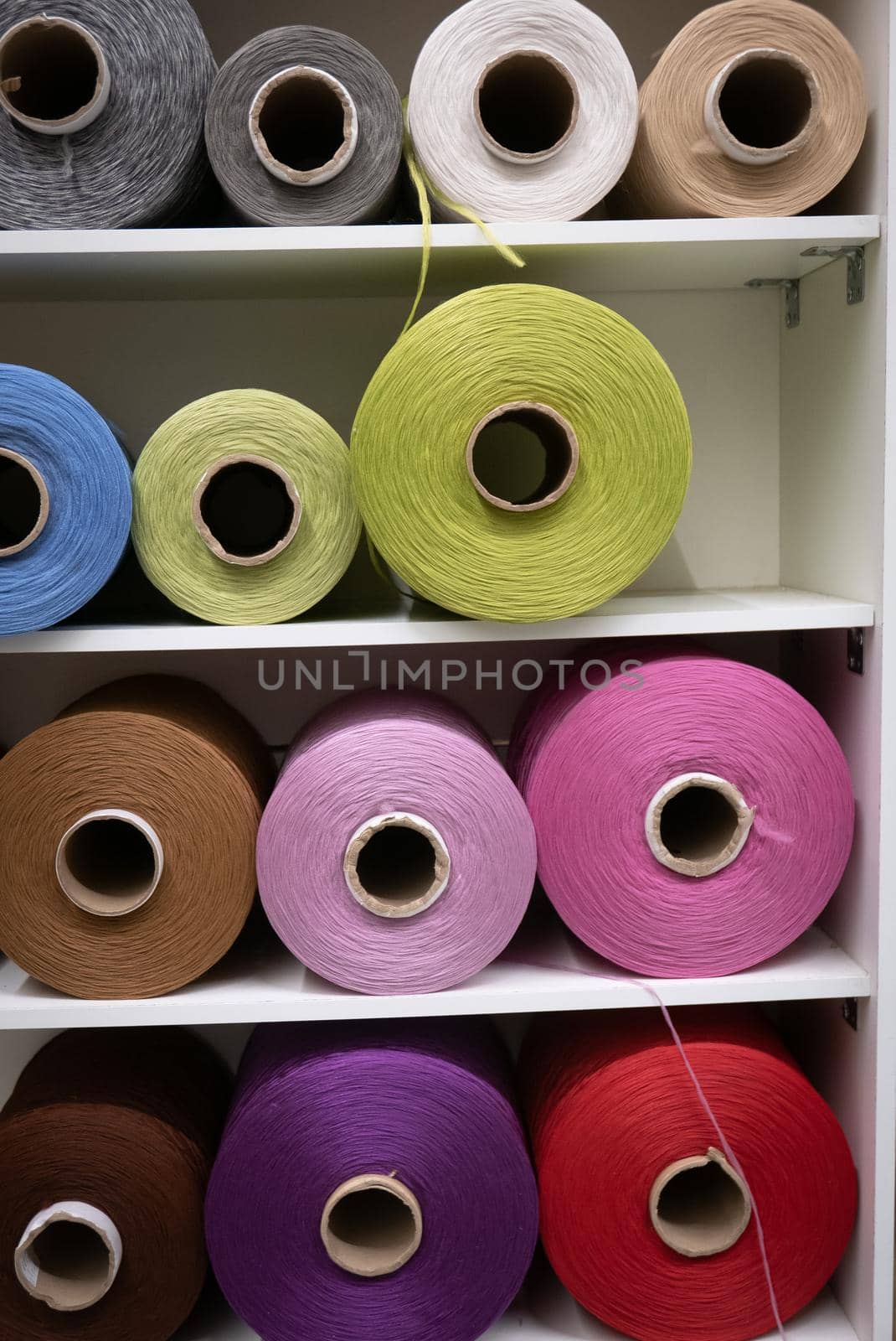 Cotton sewing threaded reels in a sewing shop.