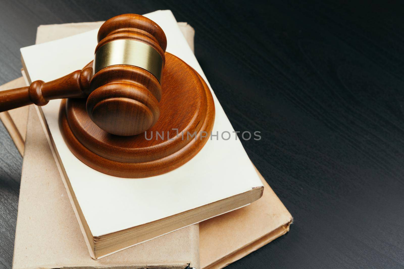 Brown wooden judge mallet on the background of open book. High quality photo