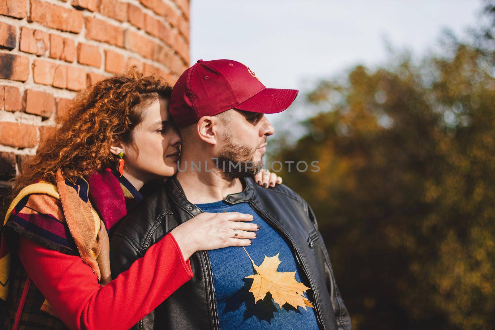 Happy couple in love embraces and has fun outside in the nature background. Woman is pregnant. Happy new parents. by mmp1206