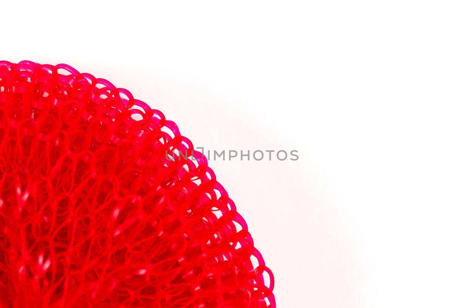 texture of red plastic shower washcloth close up. macrophotography with copy space for text.