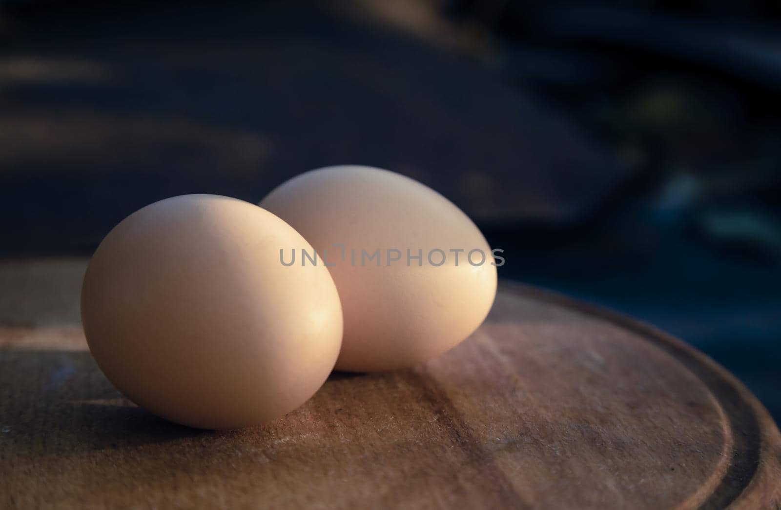 Two egg lay on the wooden table, Soft focus. Close-up two egg lay on the wooden table.