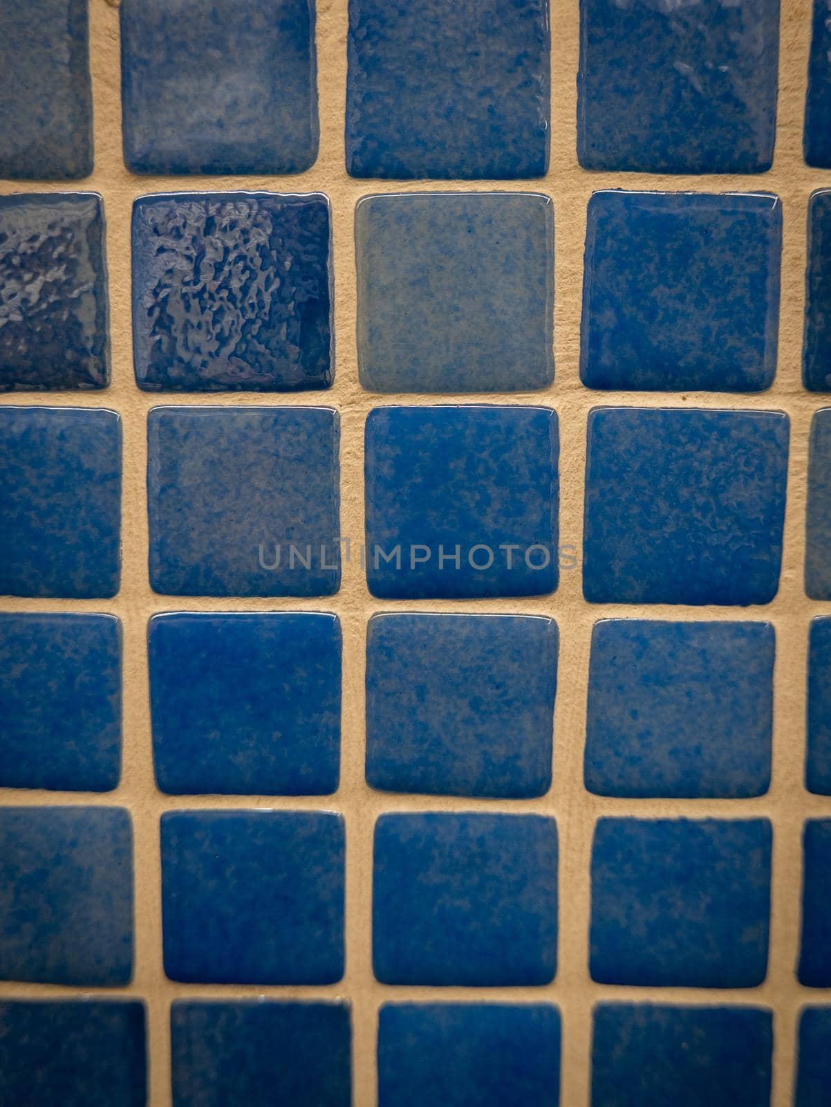 Blue ceramic mosaic on the wall as background.