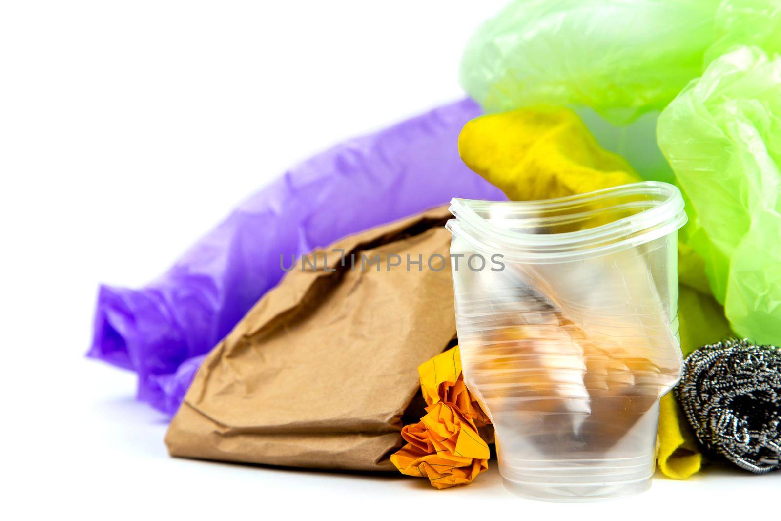Concept of garbage and pollution. A pile of trash, crumpled plastic cup, packages, paper isolate on a white background.