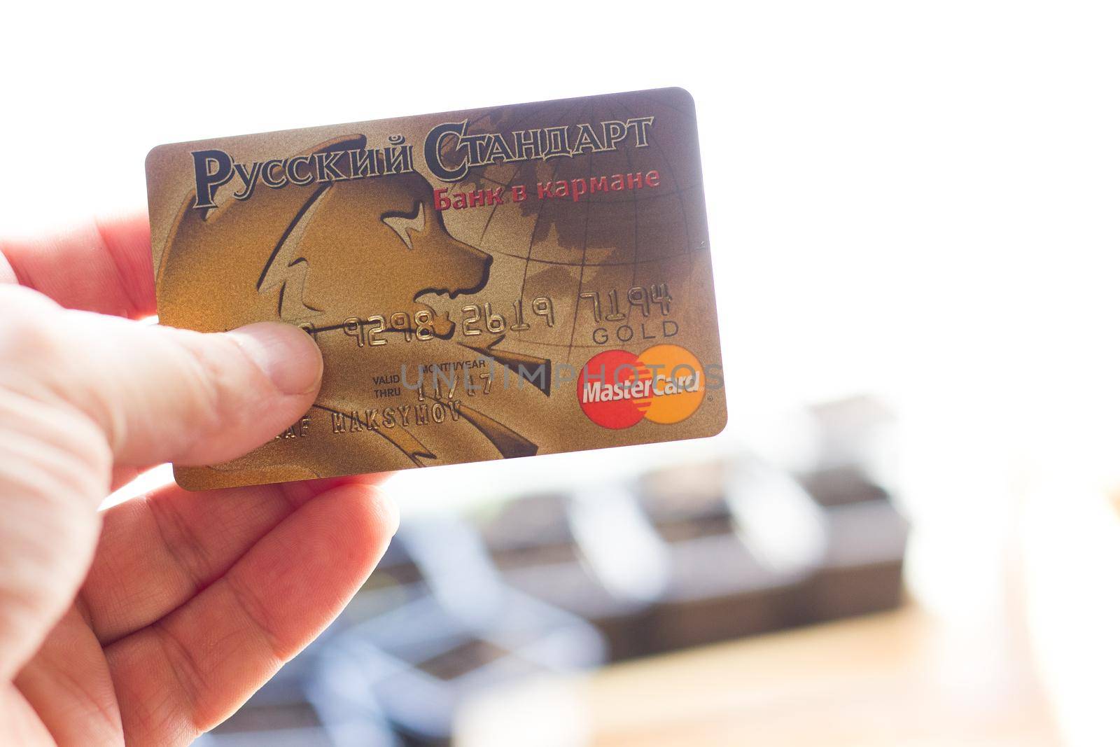 Ryazan, Russia - February 27, 2018: Customer hods Mastercard Gold ready to pay