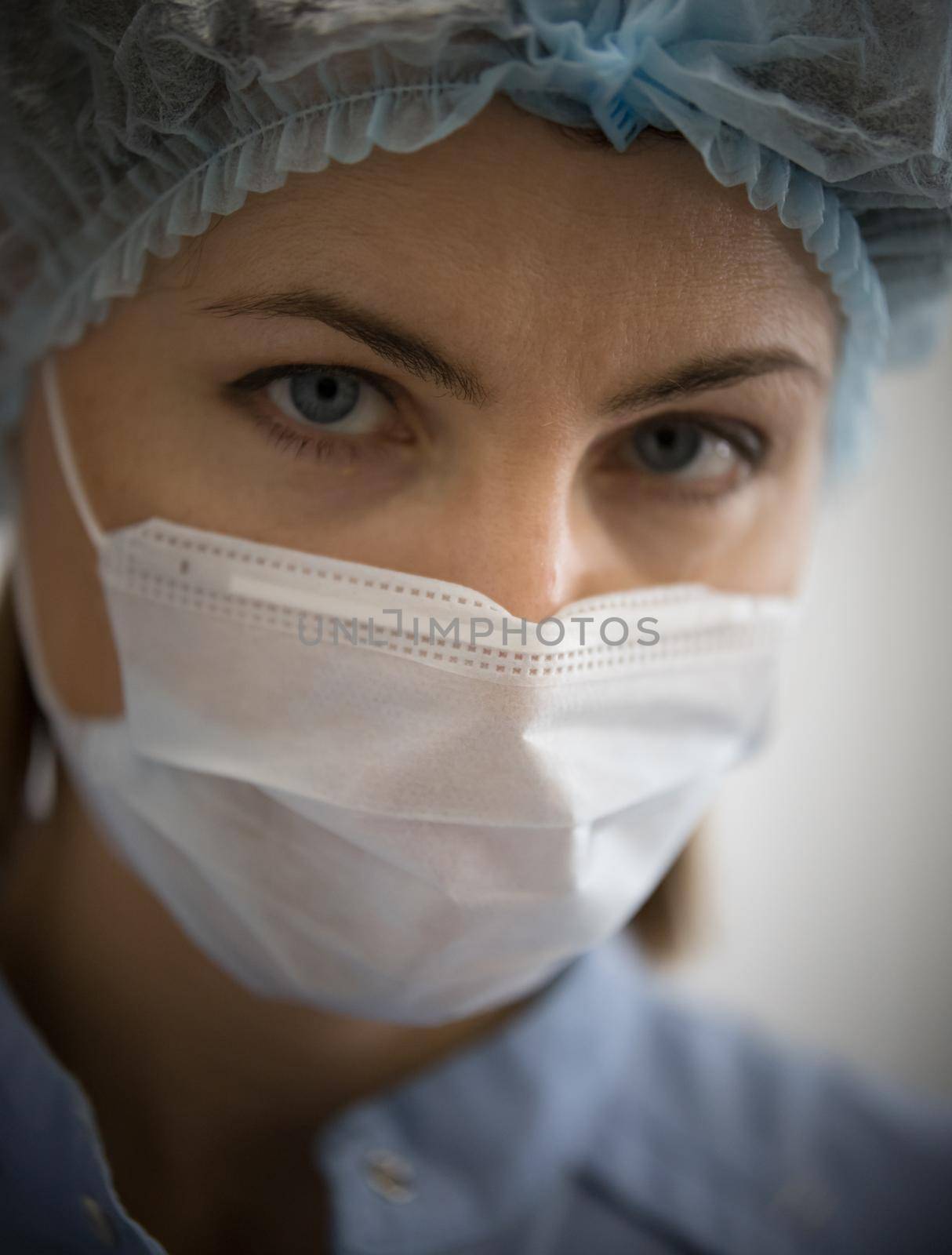 Specialist of cosmetology clinic in white protective mask. Portrait