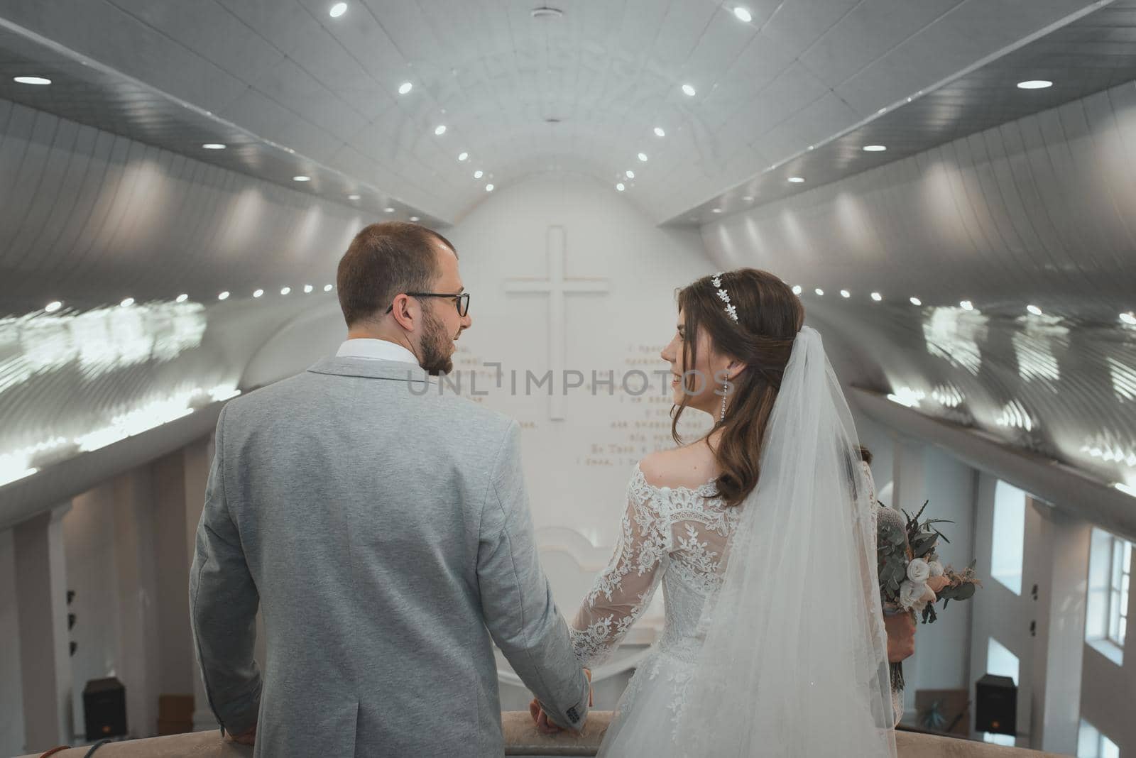 Young bride and groom on their wedding day in a church building.