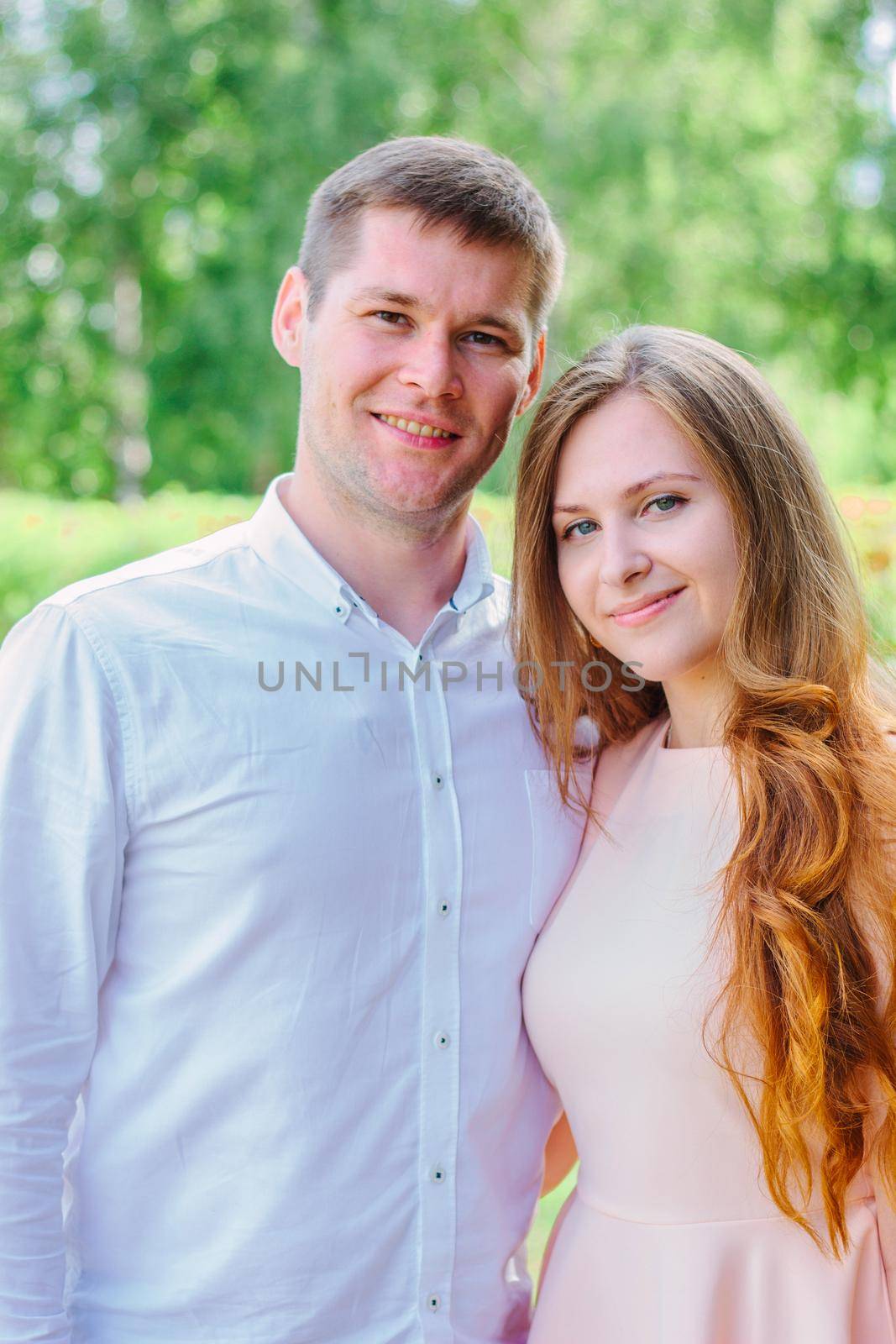 Young happy couple standing on the nature park