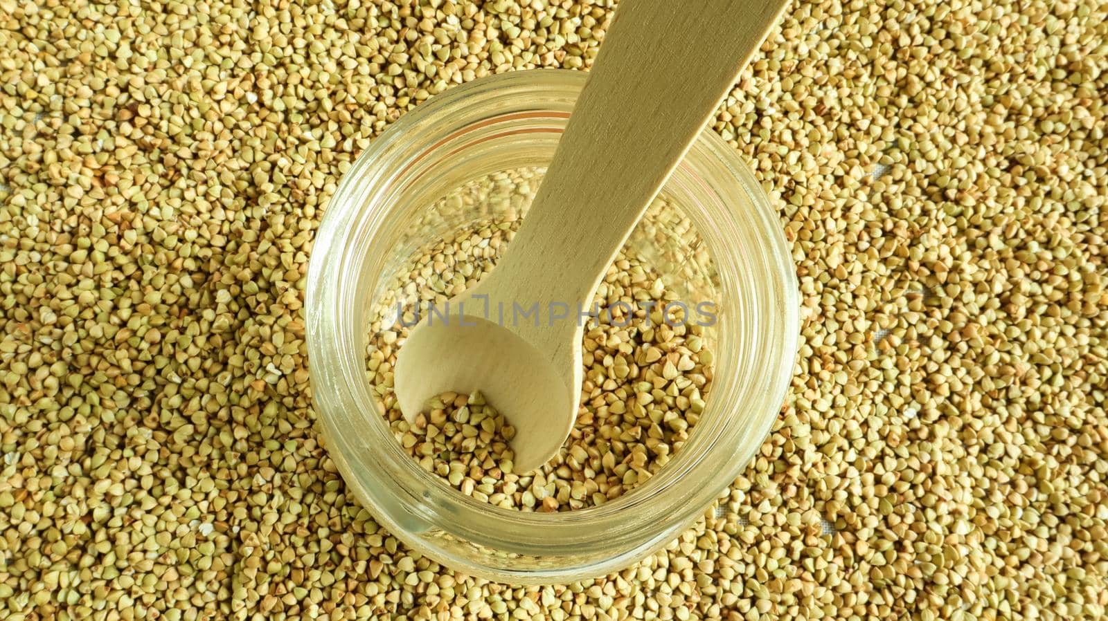 Green sprouts of raw organic buckwheat in a glass cereal jar with a wooden spoon. Vegan food concept. Organic food. The concept of diet, weight loss, healthy and proper nutrition. top view, flat lay.