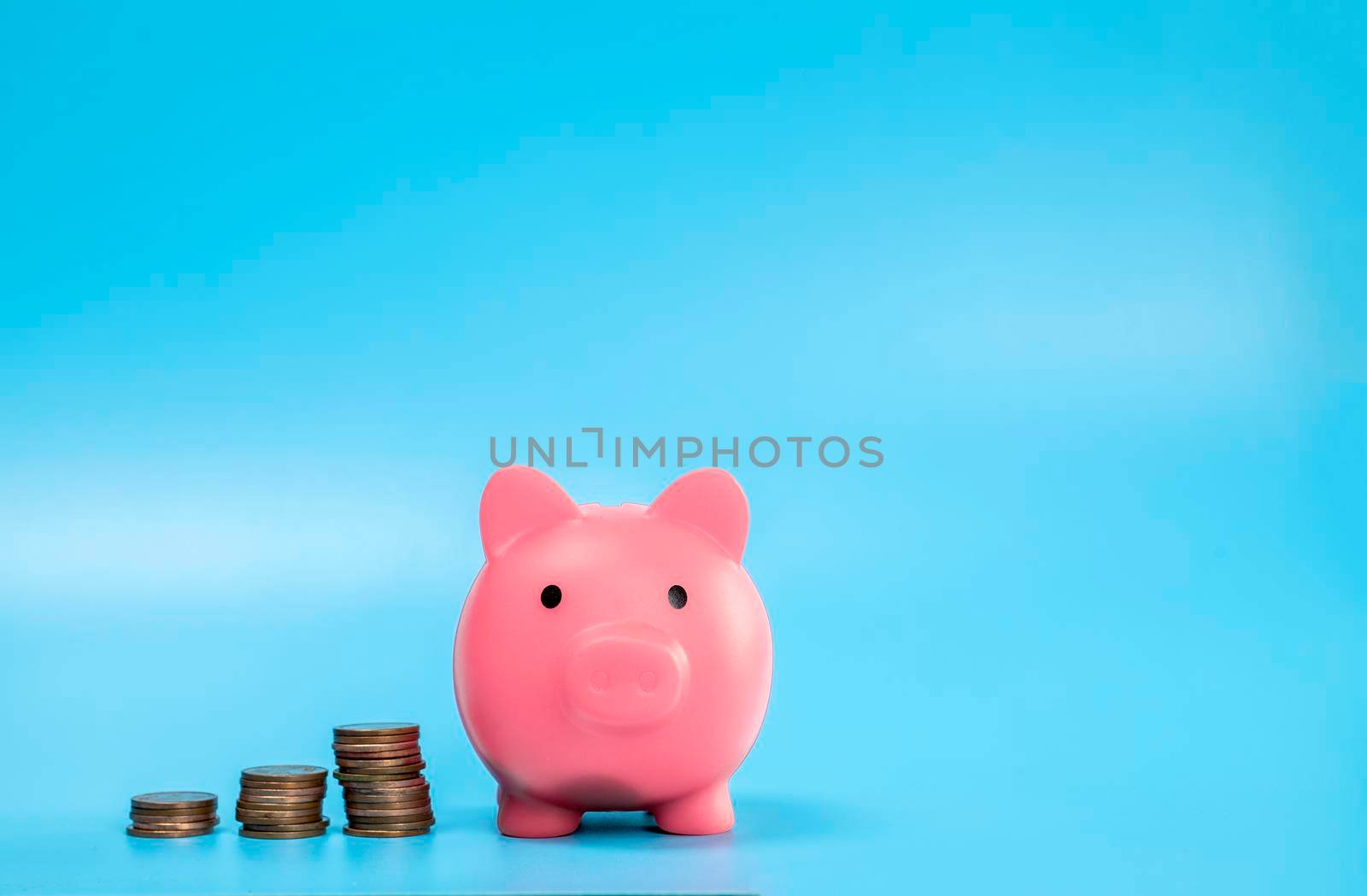 Pink Piggy Bank with stack of coins, growth and saving concept, Business and financial with copy space. by Annebel146