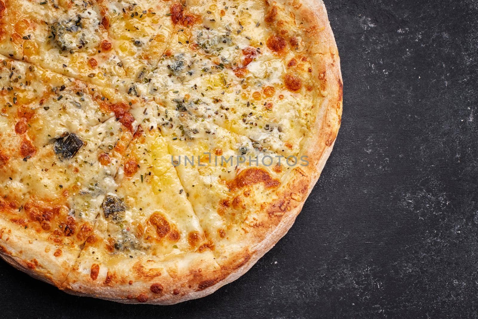4 cheese pizza on a dark background