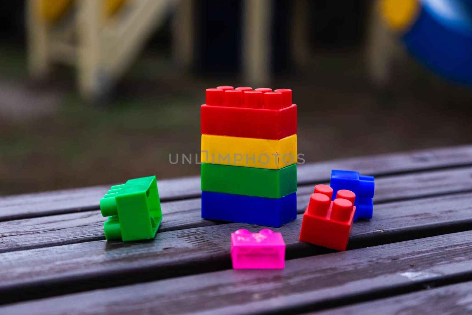 Colorful toy building blocks or bricks On wood background. by lunarts