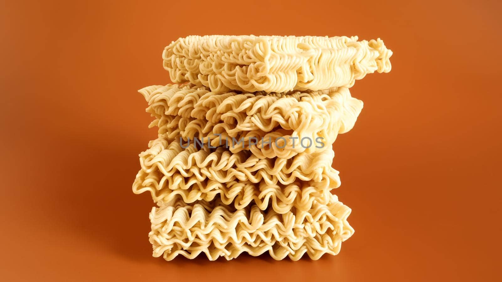 Raw dried instant noodles on a brown background. pasta, for the preparation of which it is enough to pour boiling water and wait a few minutes. Copy space. Vermicelli, spaghetti