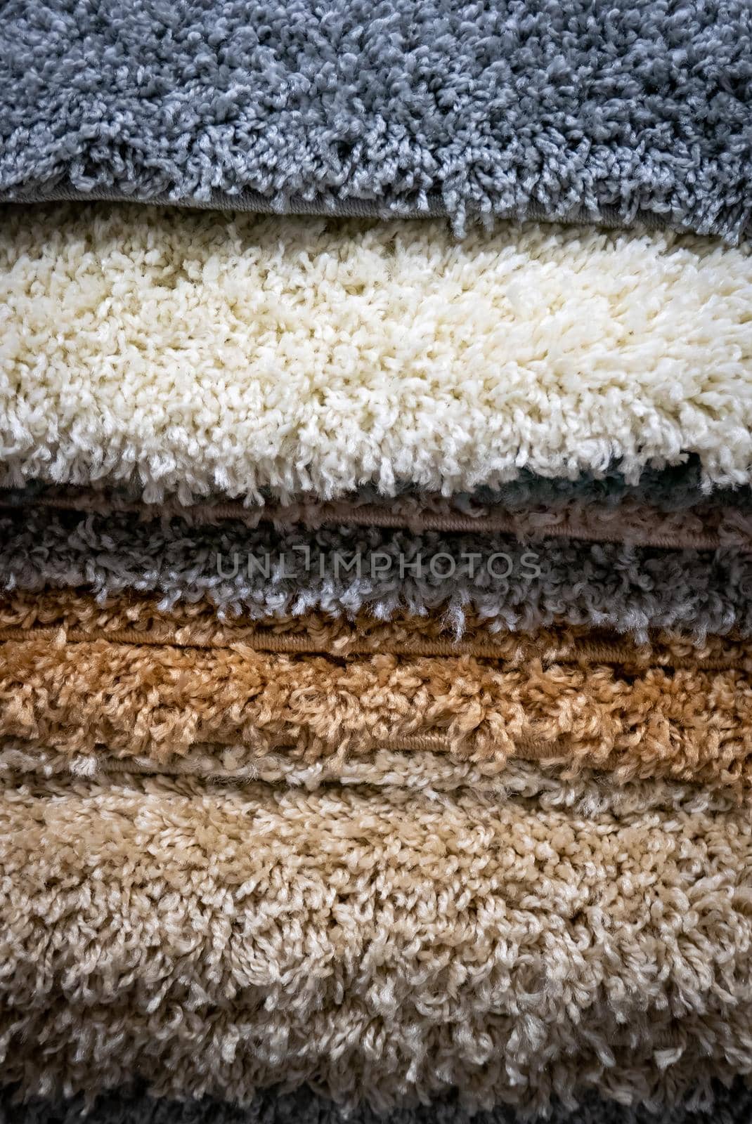 Pile of different carpets in a home decoration mall.