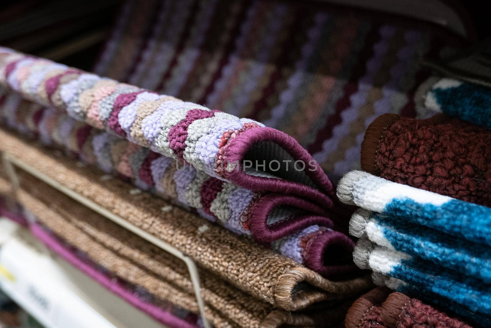 Pile of small welcome carpets or doormats.