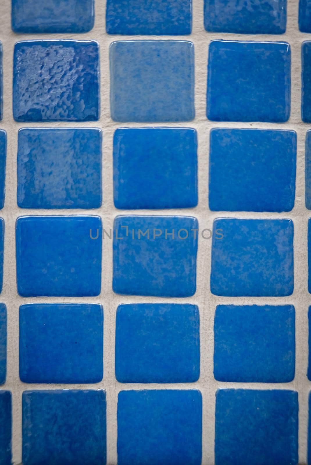 Blue ceramic mosaic on the wall as background.