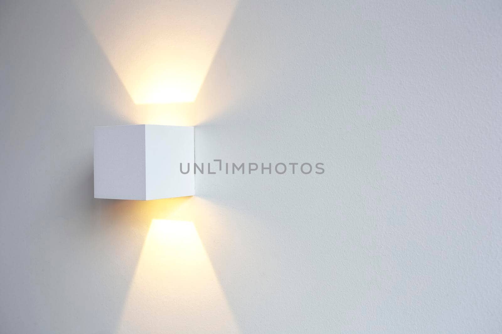 A glowing modern aluminum led lamp on white wall in retro home decoration with copy space. Luxury design by Annebel146