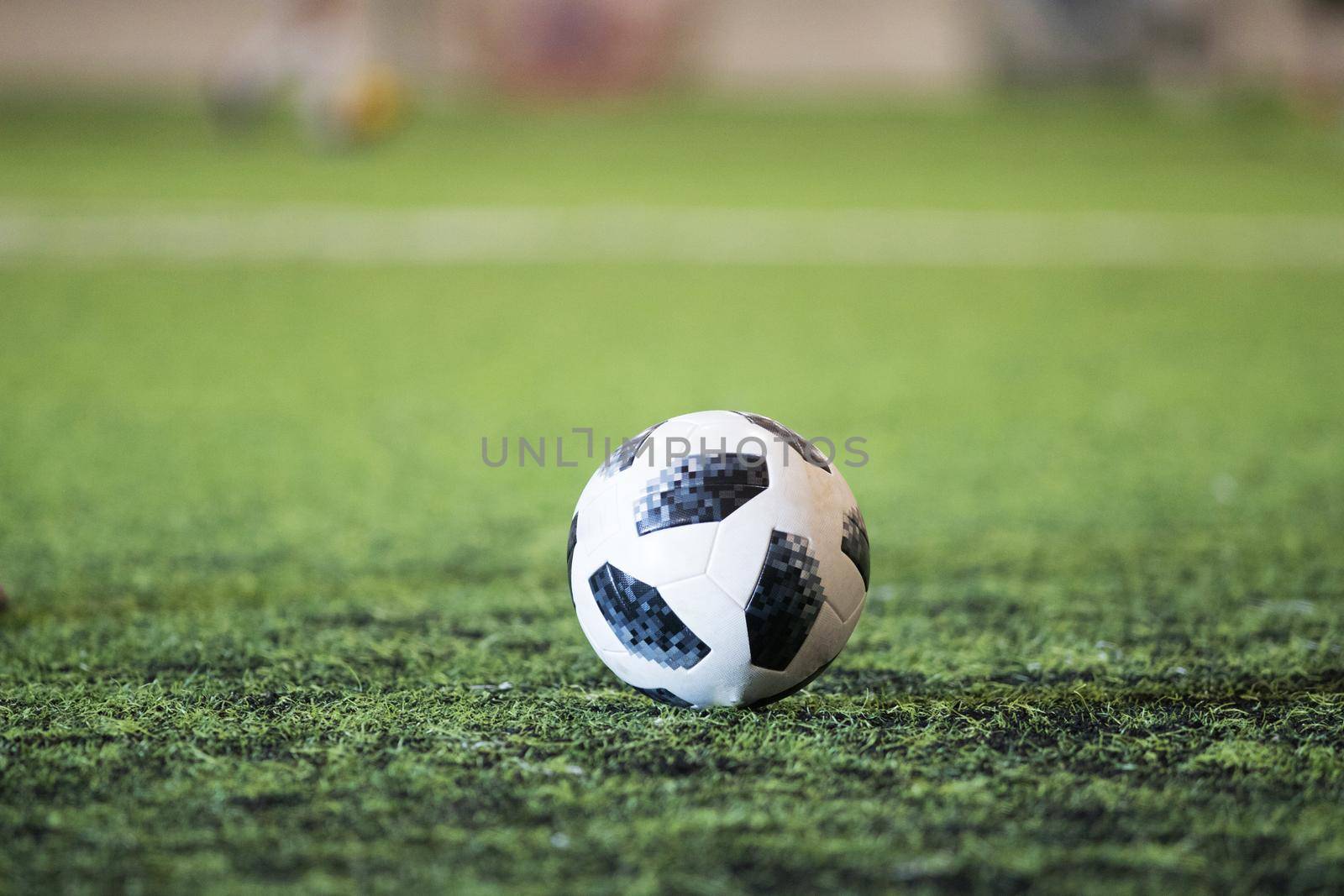 Traditional soccer ball on soccer field. Close up