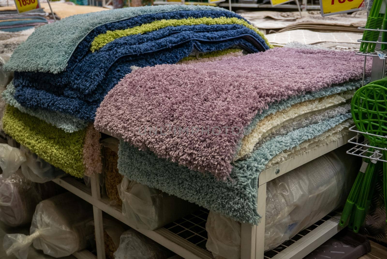 Pile of different carpets in a home decoration mall.