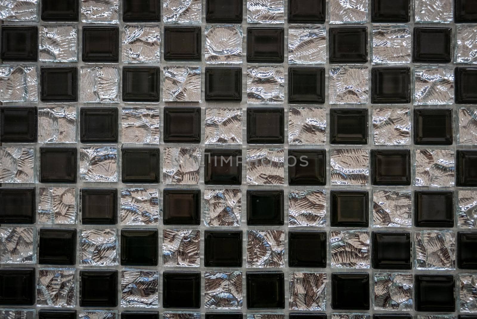 Gray ceramic mosaic on the wall as background.