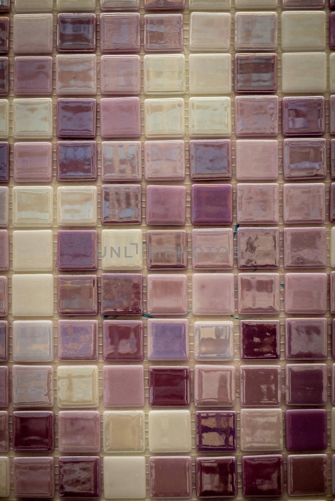 Purple ceramic mosaic on the wall as background.